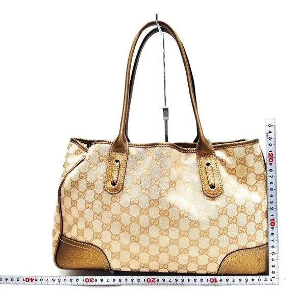 AUTHENTIC GUCCI GOLD ORIGINAL GG CANVAS PRINCY TOTE.